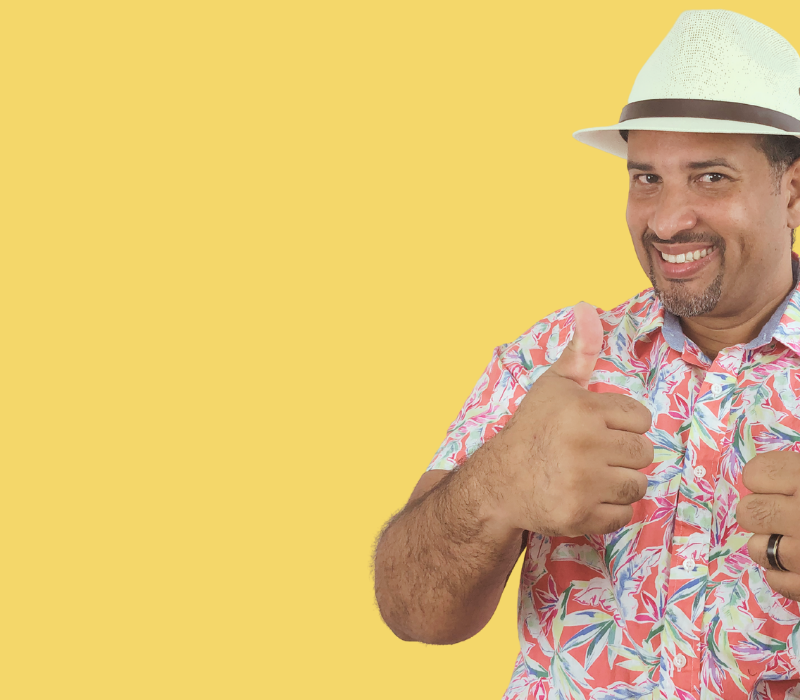 Jairo Puello is posing with his hands up as an advertisement for the music activities for Hispanic Heritage Month that he's created